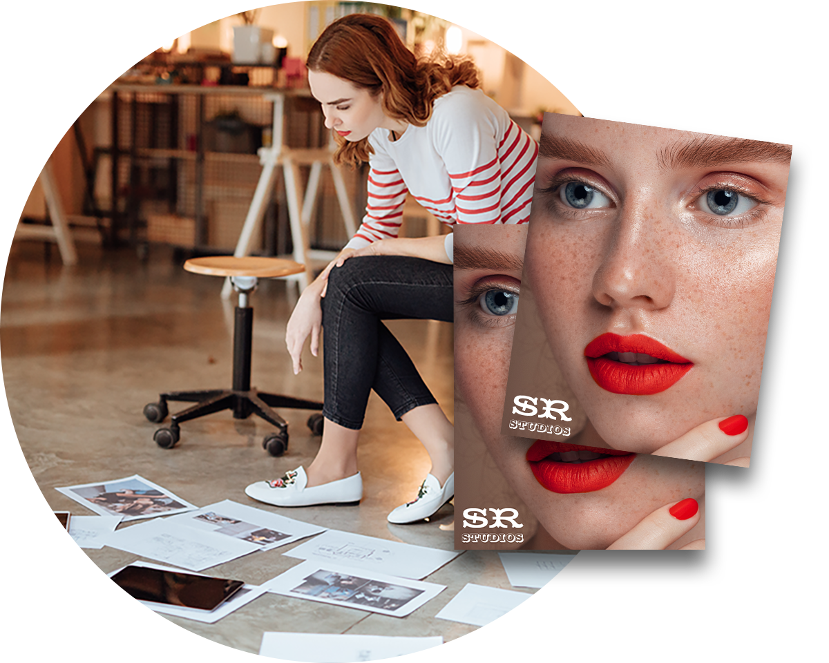 Woman sitting in a marketing and advertising agency reviewing printed work with an overly of two photograph prints.