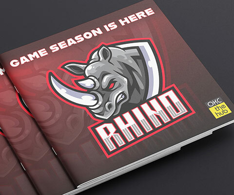 A stack of Rhino game programs. The red and black programs have the image of a mad rhino bursting through.