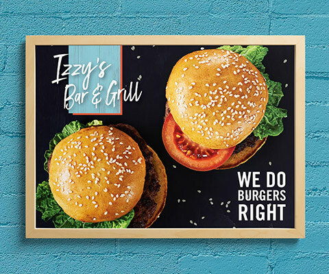 A wall poster for Izzy's Bar & Grill featuring two hamburgers on a black background. The text reads "we do burgers right."